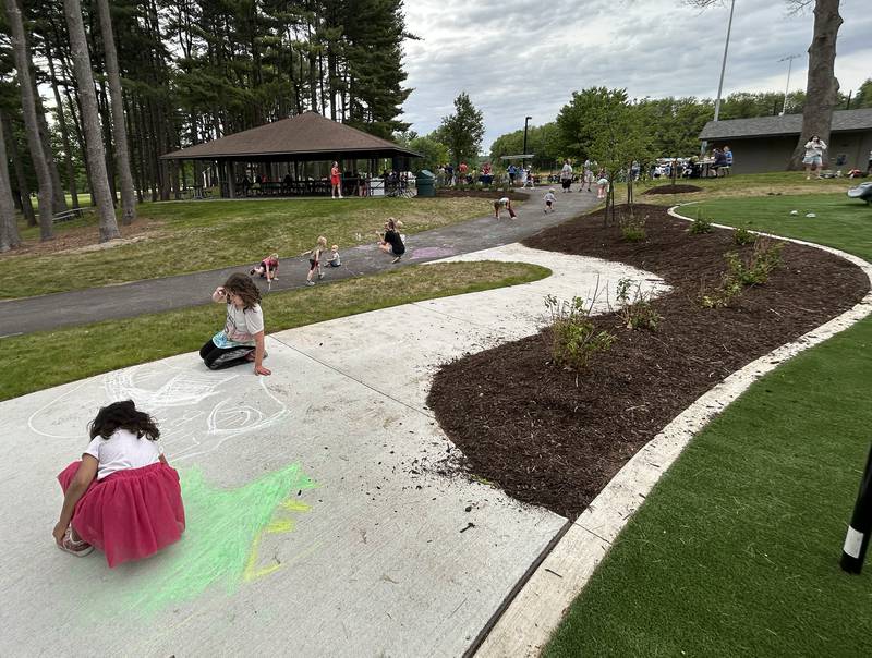 Kids create art on the sidwealk with chalk during the Oregon Park District's grand opening celebration for Park East Inland Side recreation area on Monday, May 18, 2026.