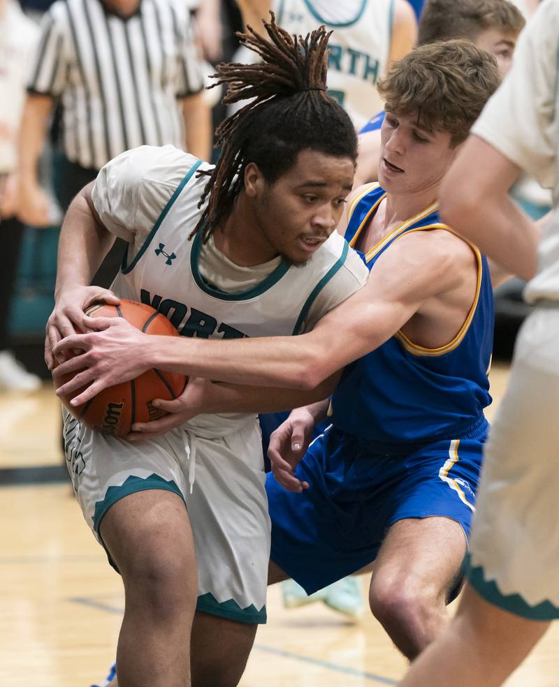 Woodstock North's Elijah White is defended by Johnsburg's Kyle Patterson during their game on Wednesday, January 31, 2024 at Woodstock North High School. Ryan Rayburn for Shaw Local
