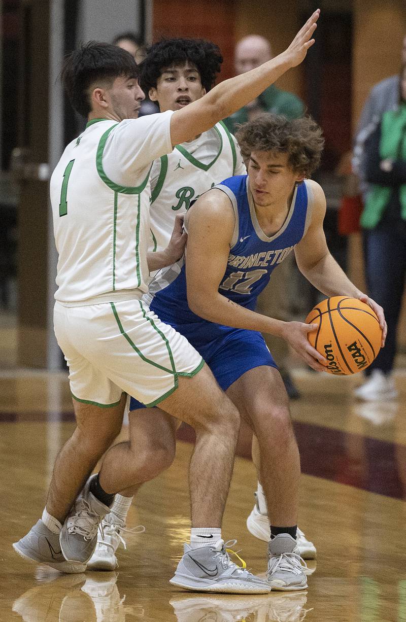 Rock Falls’ Austin Castaneda and Christian Hernandez guard Princeton’s Asa Gartin Friday, March 7, 2025, in the Class 2A boys basketball Sectional final in Marengo.