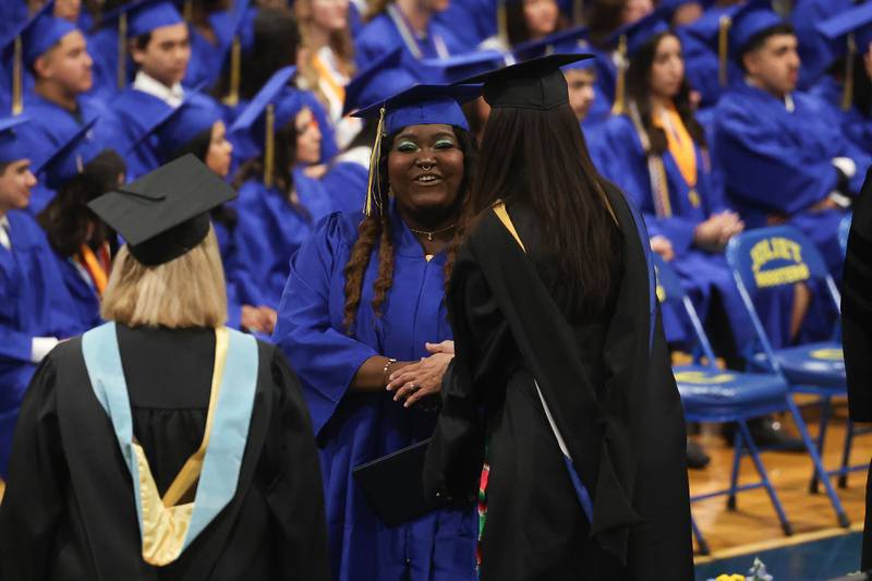 A graduate receives their diploma at the Joliet Central Class of 2023 Commencement Ceremony on Saturday, May 20, 2023, in Joliet.