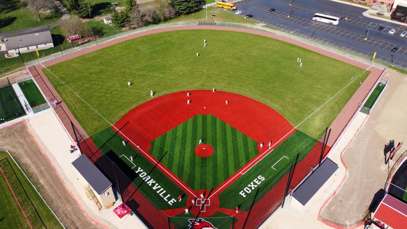 Yorkville baseball players warm up on their new turf baseball field prior to the start of their game against West Aurora at Yorkville High School on Monday, April 15, 2024.