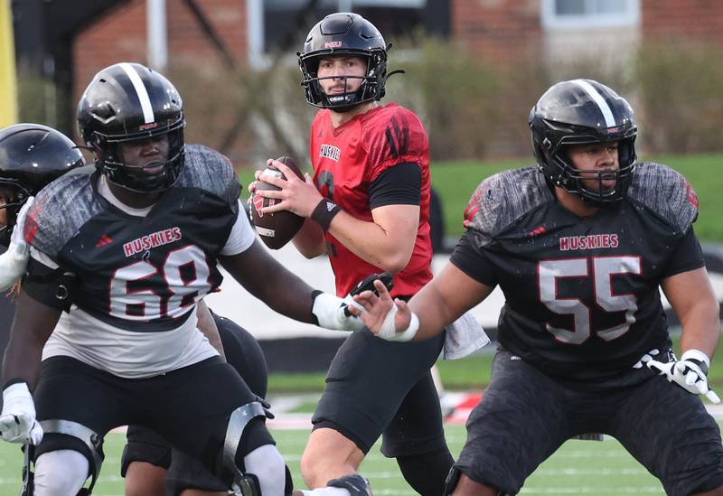 Northern Illinois University quarterback Brady Davidson gets good protection from offensive lineman Samir Senenat (left) and Ty Mead Tuesday, April 14, 2026, during spring practice in Huskie Stadium at NIU in DeKalb.
