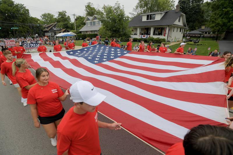 A huge American flag is carried in the annual Wheaton Independence Day Parade on Thursday, July 4, 2024.