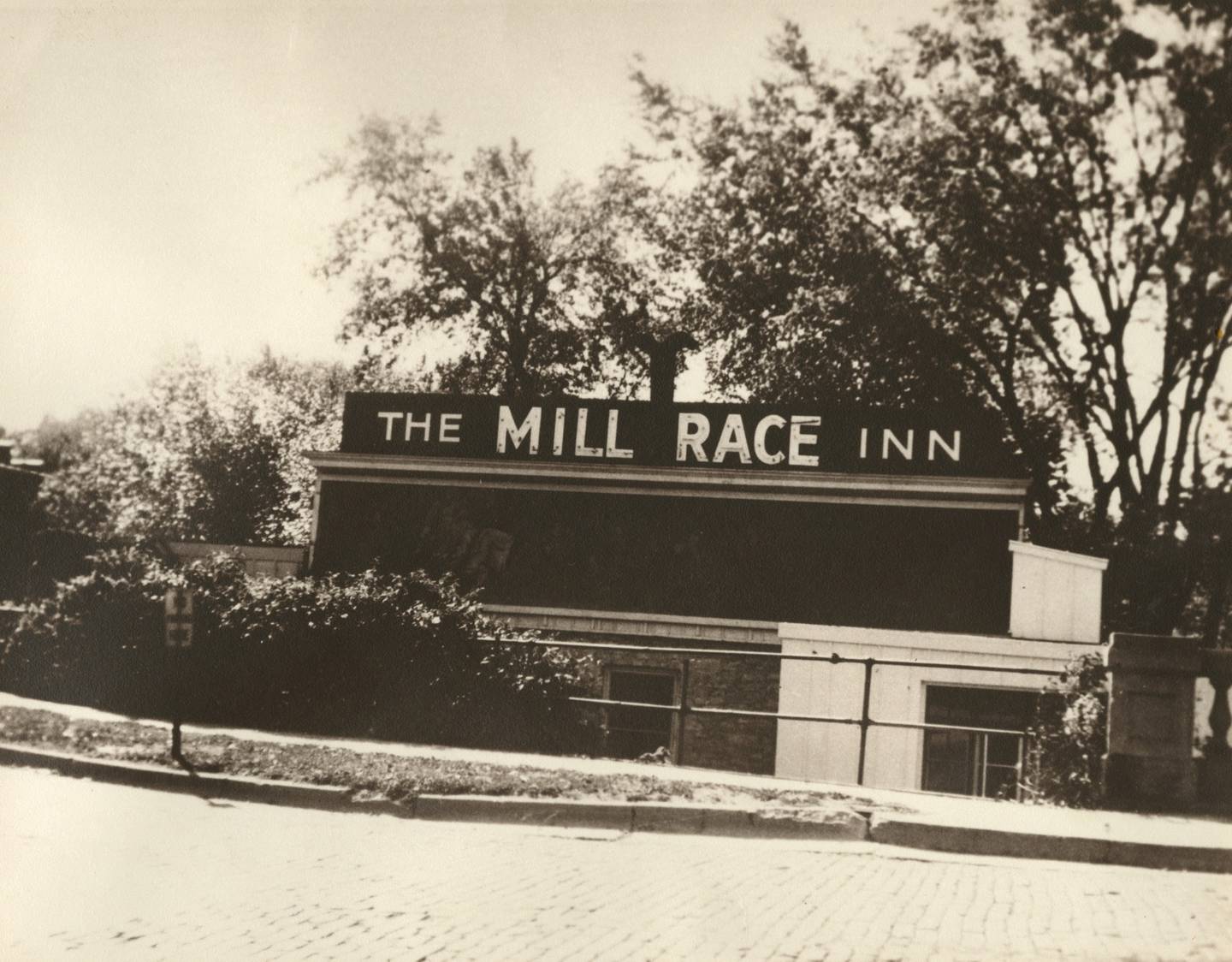 The Mill Race Inn sign by the State Street bridge in Geneva in the 1940s.