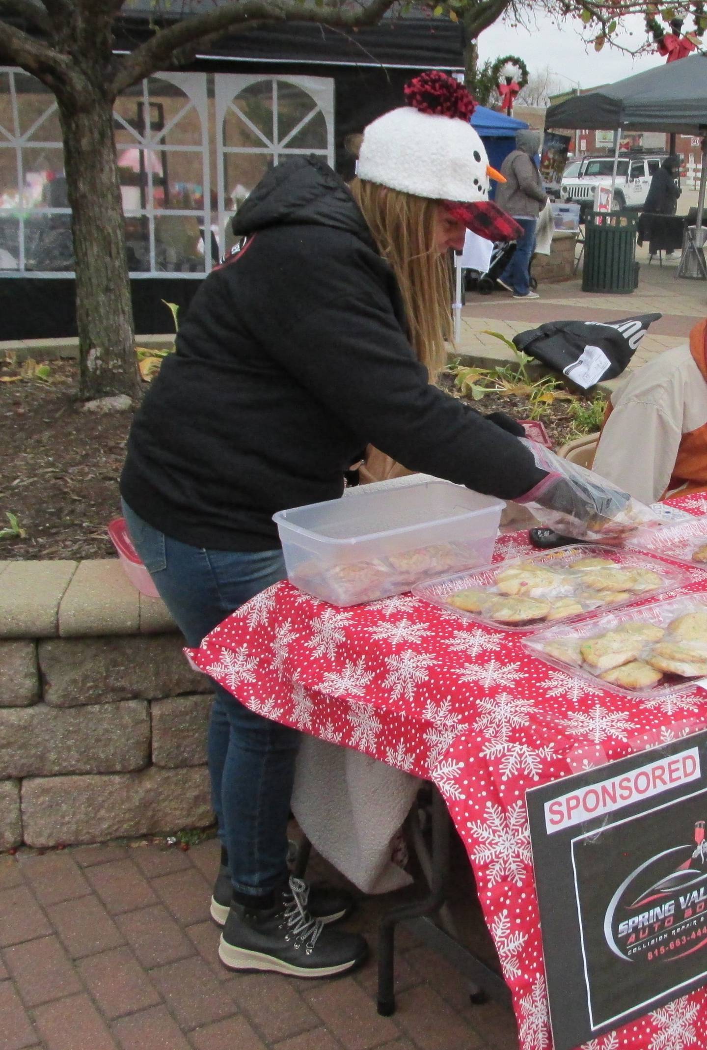 Diane DeJong puts out cookies Saturday, Nov. 12, 2022, during the Christmas in the Valley market in Spring Valley. Spring Valley Auto Body made cookies to gather donations for the food pantry. Leftover cookies were donated to the Spring Valley Youth Center.