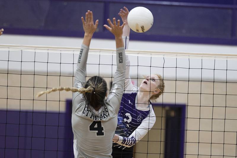 Dixon’s Madyson Tichler hammers a shot against Galesburg’s Kiarra Kilgore Thursday, Oct. 27, 2022 in the volleyball regional final.