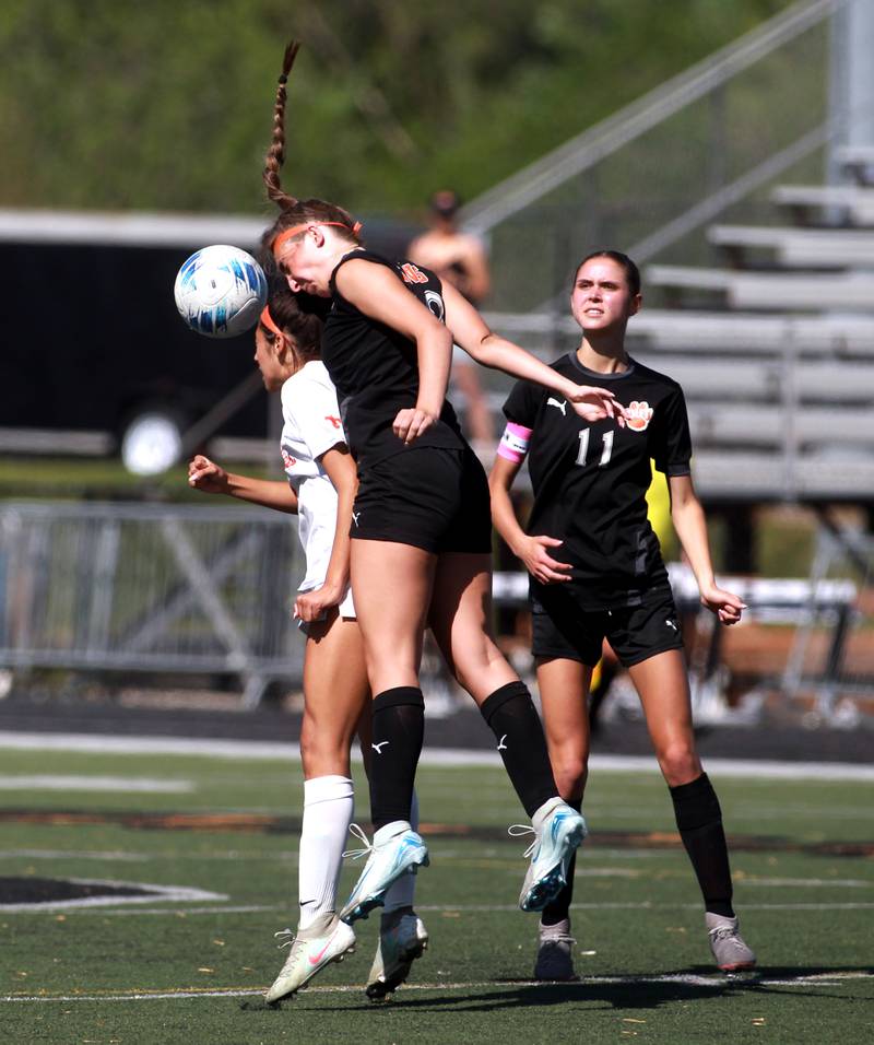 St. Charles East's Mya Leon and Wheaton Warrenville South's Kayla Waterman head the ball during a game on Friday, May 16, 2025 in Wheaton.