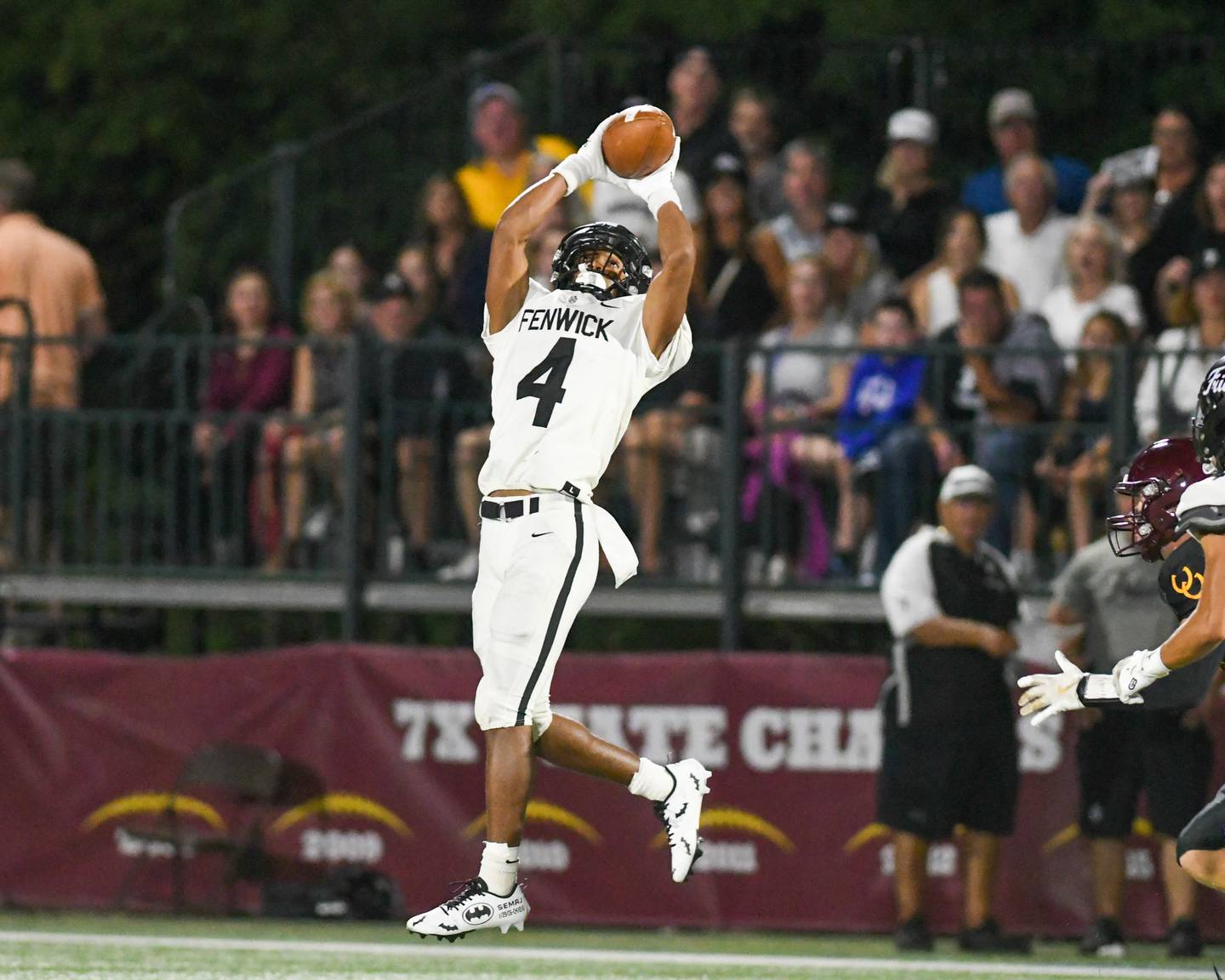 Fenwick's Raphiel Stewart (4) catches a pass and runs in for a touchdown during the game on Friday Sept. 19, 2025, while traveling to take on Montini Catholic High School.