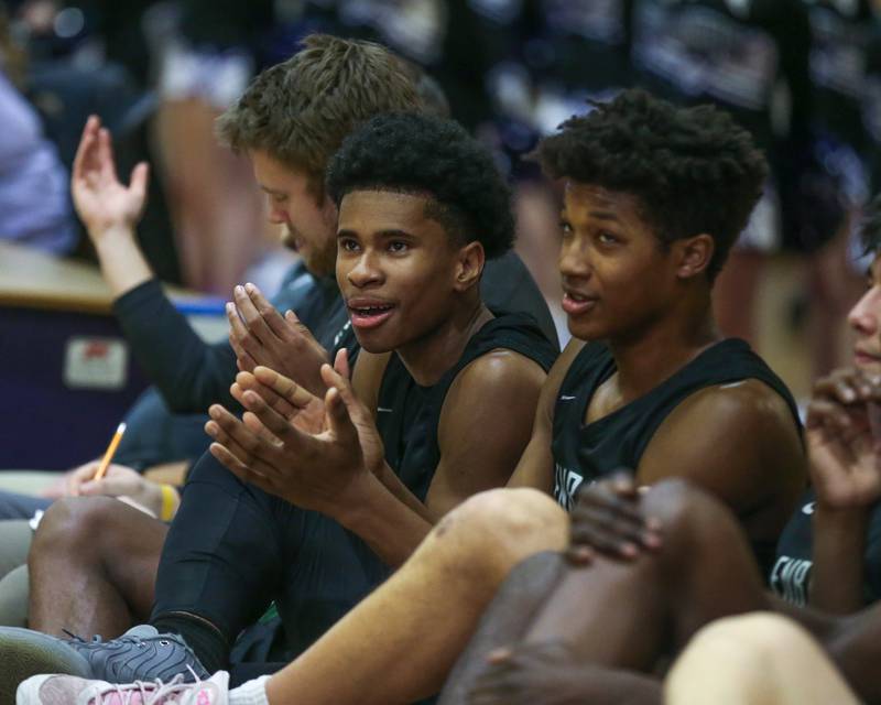 Glenbard West's TJ Williams (3) cheers on the team from the bench during their basketball game between Glenbard West at Downers Grove North. Jan 24, 2025 in Downers Grove.