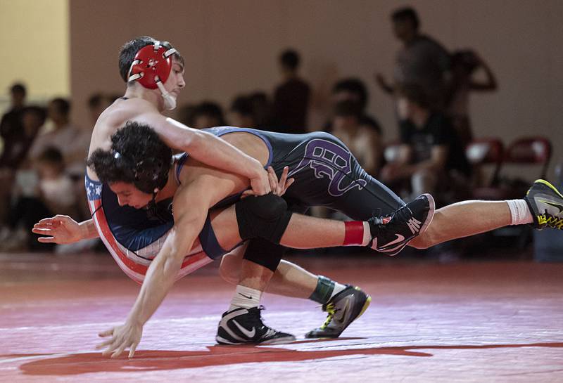 Dixon’s Preston Richards (right) and Morrison’s Mason Grismore face off in the 150 pound weight class in the Class 1A wrestling sectionals at Oregon.