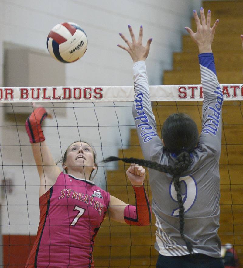Streator’s Ava Gwaltney sets to hit while Wilmington’s Kate Grosso sets to block during the 1st set of Tuesday’s match at Streator.