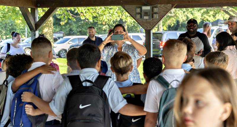 Carla Fiessinger snaps a photo of St. Anne students in Dixon on Wednesday, Aug. 13, 2025, as they return to class for the 2025-26 school year.