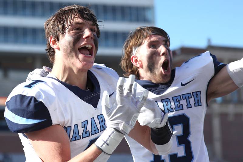 Nazareth's Zach Hayes (left) and Brady Gorman celebrate their IHSA Class 5A state championship win over Peoria Saturday, Nov. 26, 2022, in Memorial Stadium at the University of Illinois in Champaign.