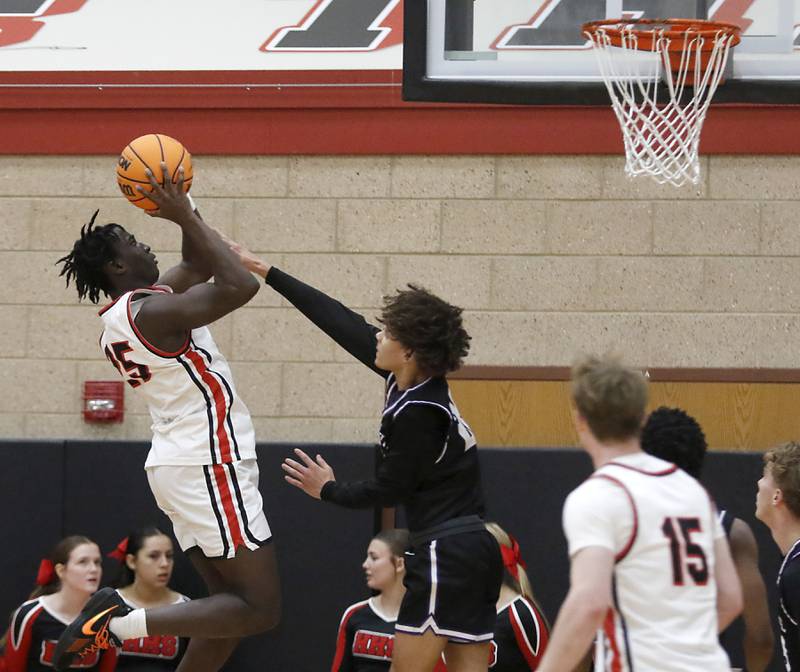 Huntley's Sheldon Aninagyei Bonsu shoots the ball over Hampshire's Jaiden Baldwin during a Fox Valley Conference boys basketball game on Friday, Dec. 8, 2024, at Huntley High School.
