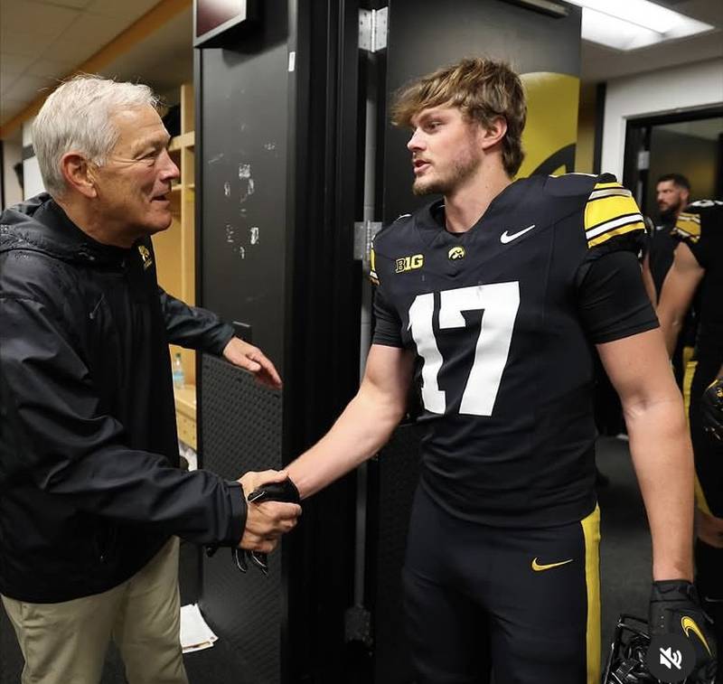 Princeton's Teegan Davis, a sophomore redshirt for the Hawkeyes, is greeted by Iowa head coach Kirk Ferentz. after a home game this season in Iowa City. Davis made his third bowl trip with the Hawkeyes to the ReliaQuest Bowl in Tampa, Fla.