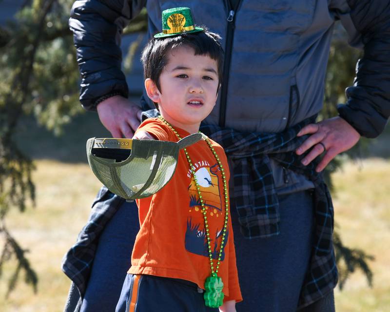 Owen Tran, 5, of Countryside holds out his hat in preparation for candy during the Countryside St. Patrick’s Day parade held on Saturday March 1, 2024.