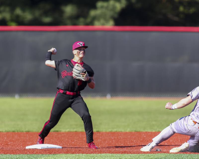 Yorkville's Justin Giese (8) throws to first while the runner starts his slide during baseball game between Oswego at Yorkville. Thursday, May 8, 2025 in Yorkville.
