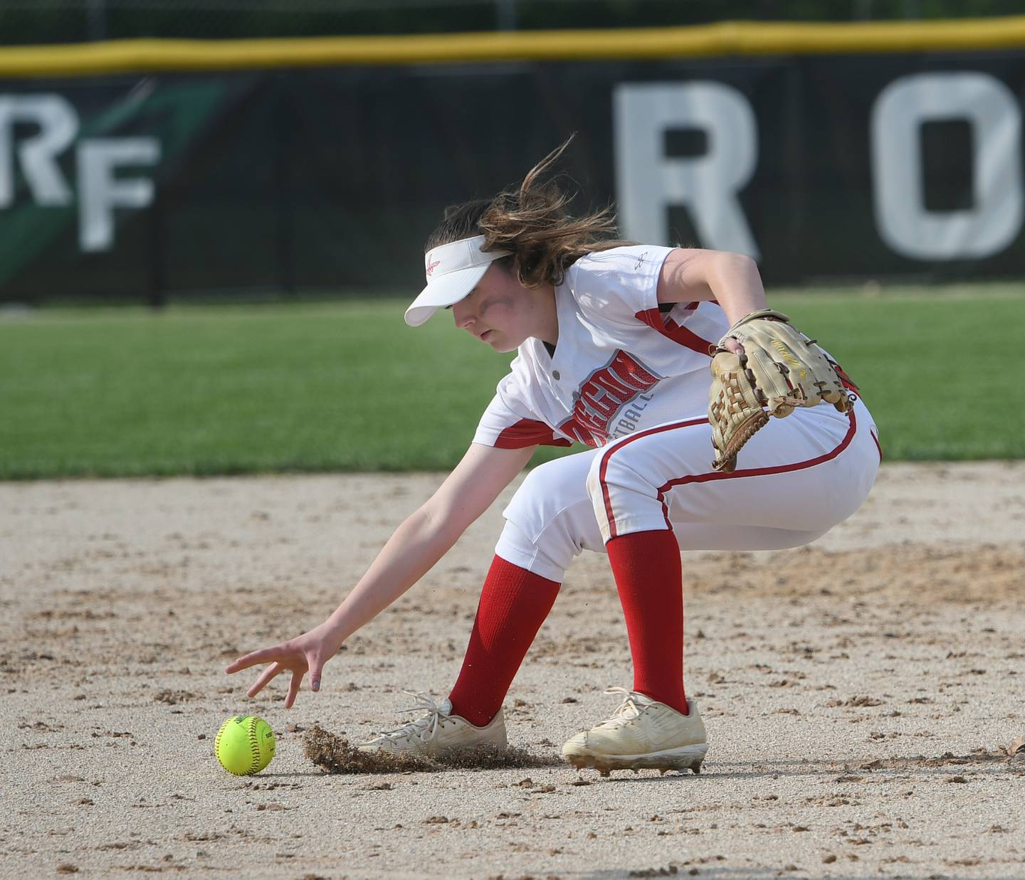 Oregon shortstop Reilee Suter reaches for the ball after it was deflected by pitcher Mia Trampel during Wednesday's regional game with Byron.