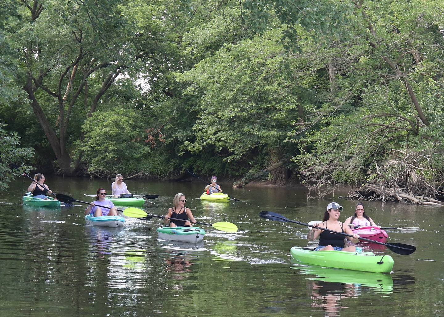 Kayakers paddle downstream in the Kishwaukee River Sunday, July 31, 2022, from the ramp at David Carrol Memorial Citizens Park in Genoa.