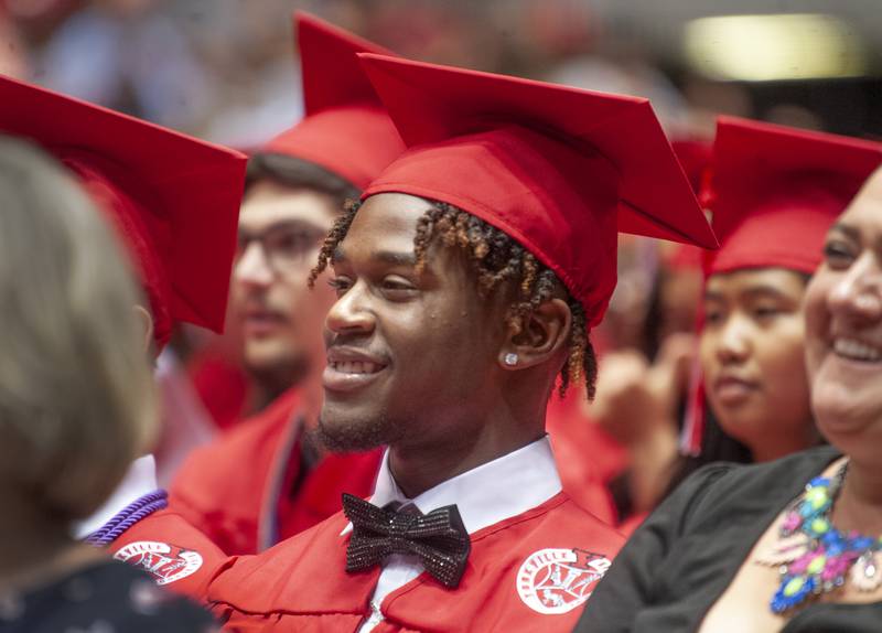 Donning a shiny bowtie, graduate Malachi Jones, is all smiles during Yorkville High School's class of 2022 graduation ceremony at the NIU Convocation Center on Friday, May 20, 2022.