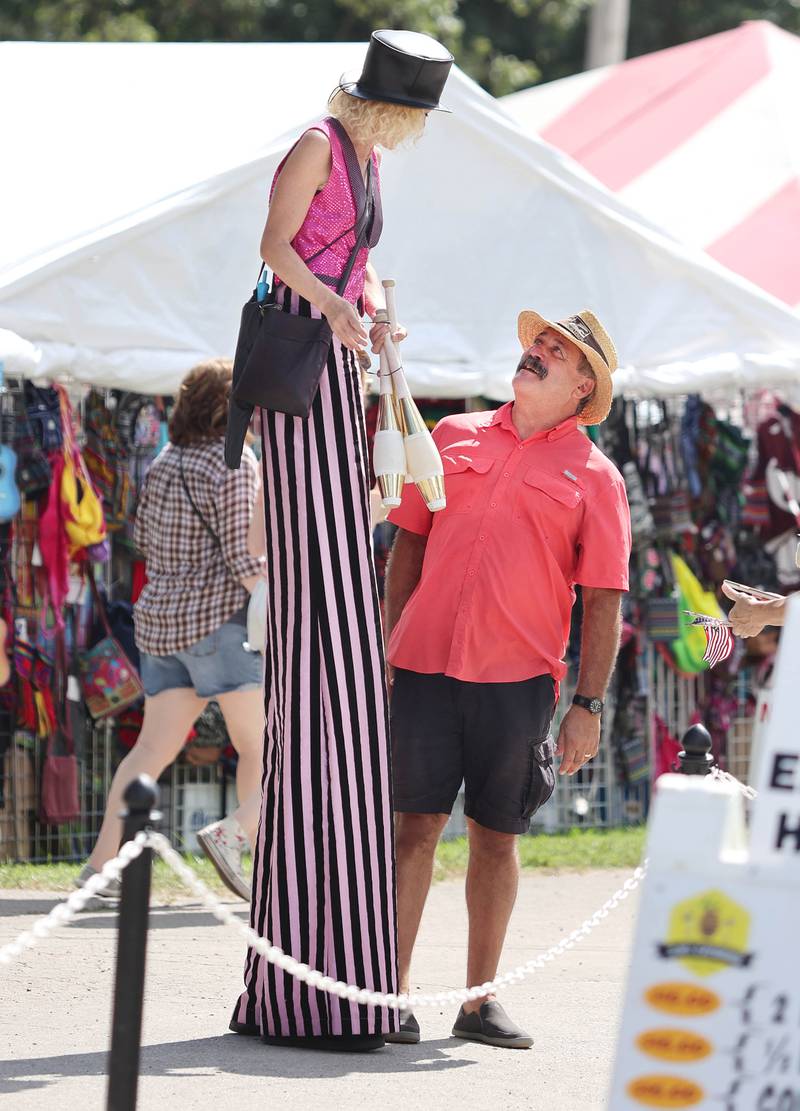 One of the traveling performers greets a visitor Wednesday, Sept. 7, 2022, on opening day of the Sandwich Fair. The fair continues this week through Sunday.