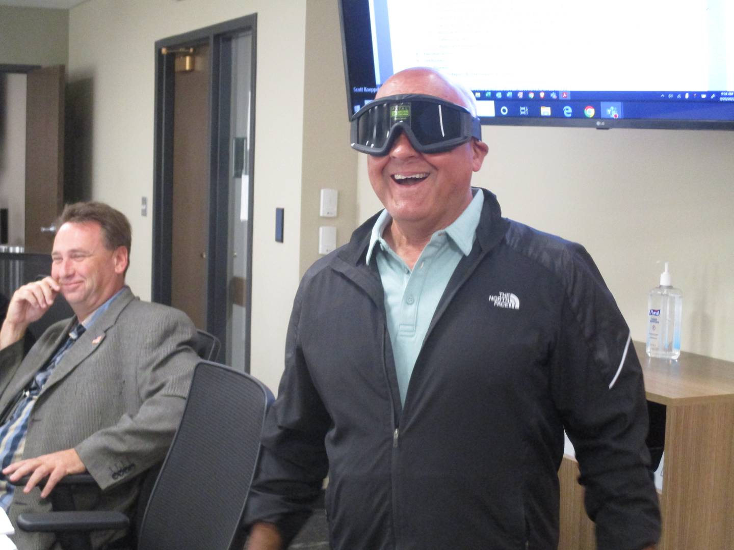 Kendall County Board member Ruben Rodriguez reacts to the change in his visual perception while wearing goggles designed to simulate the effects of marijuana on Sept. 20, 2022.