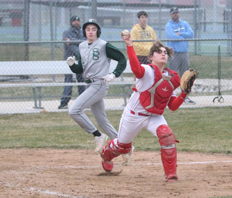 Ottawa catcher Packston Miller throws to first base to make double play as St. Bede's Alex Ankiecz is forced out at home on Wednesday, March 22, 2023 at Ottawa High School.
