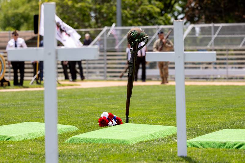 The Soldiers Cross stands in front of memorial markers on Monday, May 26, 2025 at Washington Park in Peru.