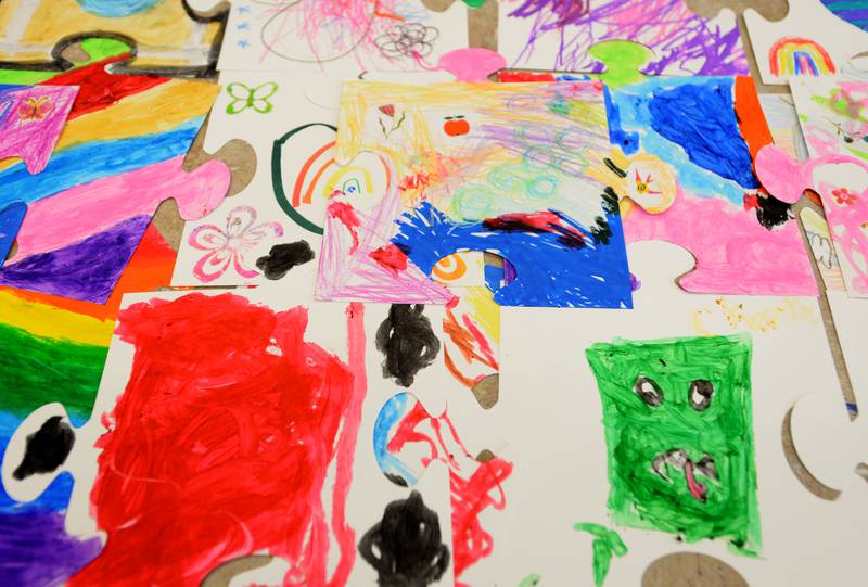 Children participate in creating a mural during the Unplug Illinois Day held at the Downers Grove Park District Saturday July 8, 2023.