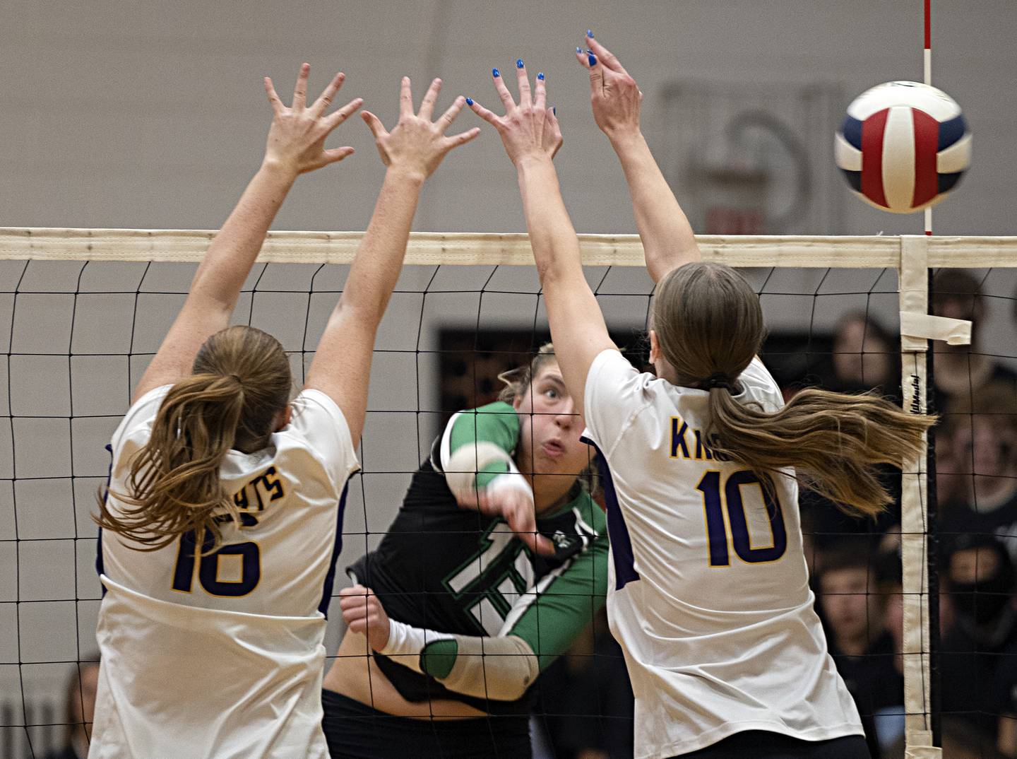 Rock Falls’ Claire Bickett hammers a shot against Chicago Christian’s Ashley Hinshaw (left) and Chase Grevengoed  Friday, Nov. 3, 2023 in the class 2A volleyball supersectional in Sandwich.