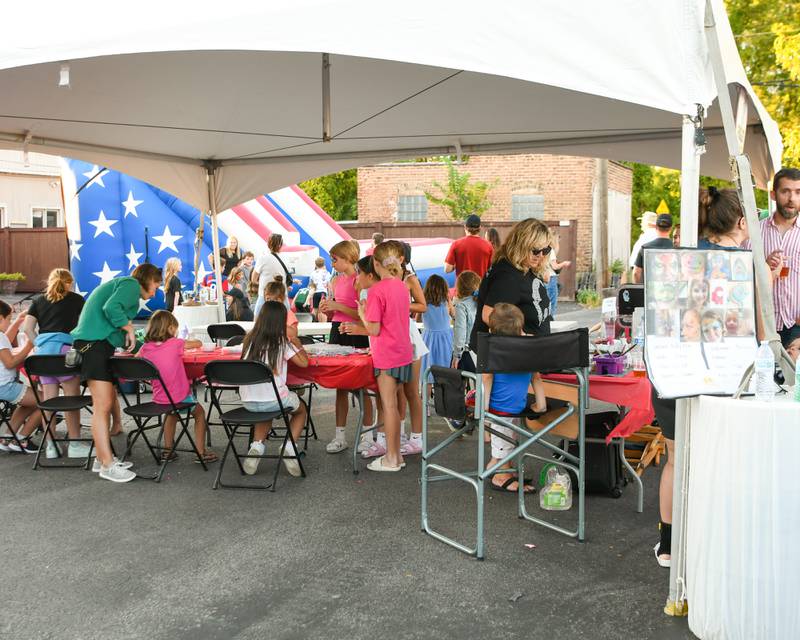 Kids enjoy the kid’s area during the Cure for a Cause event held on Sunday Sep. 1, 2024, in downtown Elmhurst.