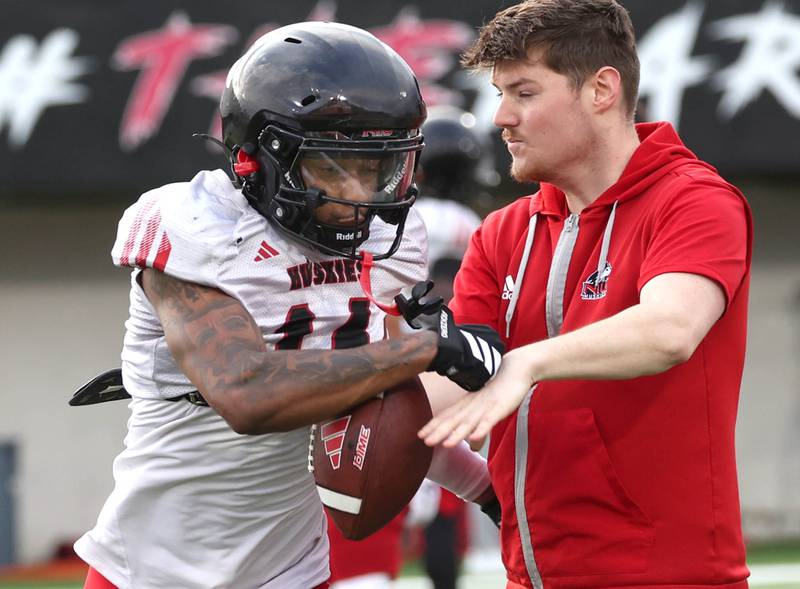 Northern Illinois University safety Malik Armstrong works on forcing a fumble Tuesday, April 14, 2026, during a drill at spring practice in Huskie Stadium at NIU in DeKalb.