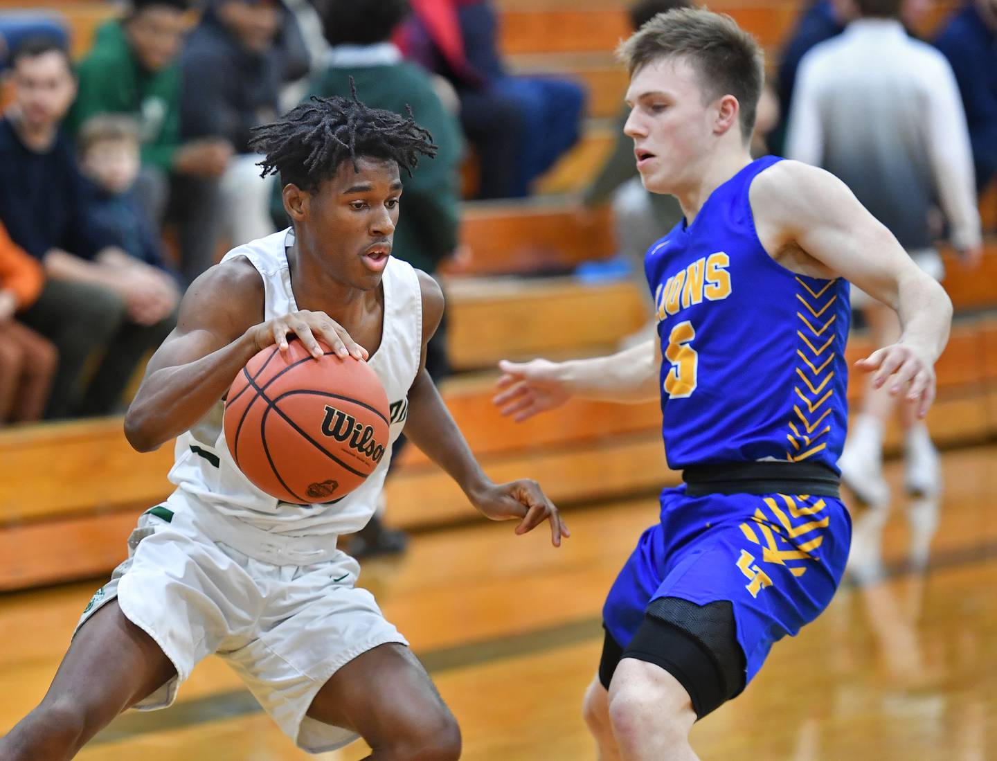 Glenbard West's Benji Zander drives as Lyons Township's Jackson Niego (5) defends during a game on Dec. 10, 2022 at Glenbard West High School in Glen Ellyn.