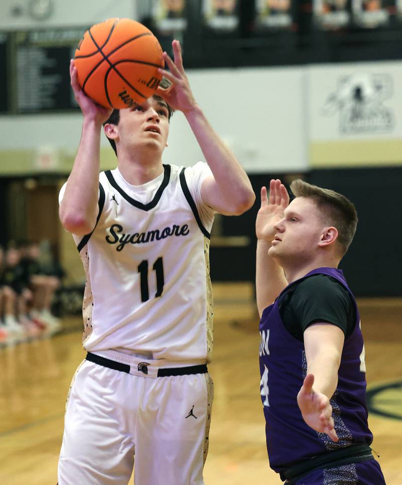Sycamore's Jake Shipley shoots over Dixon’s Eli Davidson during their game Tuesday, Jan. 14, 2025, at Sycamore High School.