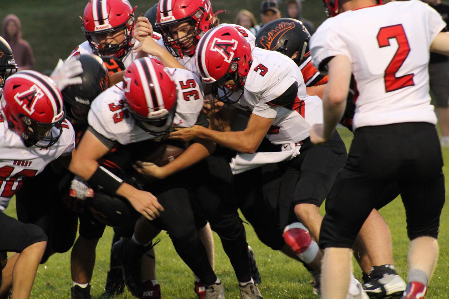 Amboy's Joe Quest (35) takes a handoff from quarterback Tucker Lindenmeyer (3) on Friday, Sept. 3, 2021, in 8-man football in Milledgeville.