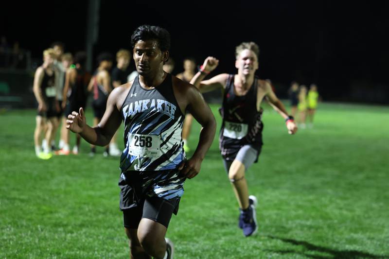 Kankakee's Jace Tucek finishes just ahead of Bradley-Bourbonnais' Christian Winstrom during the All-City cross country meet at Bishop McNamara on Wednesday, Sept. 17, 2025.
