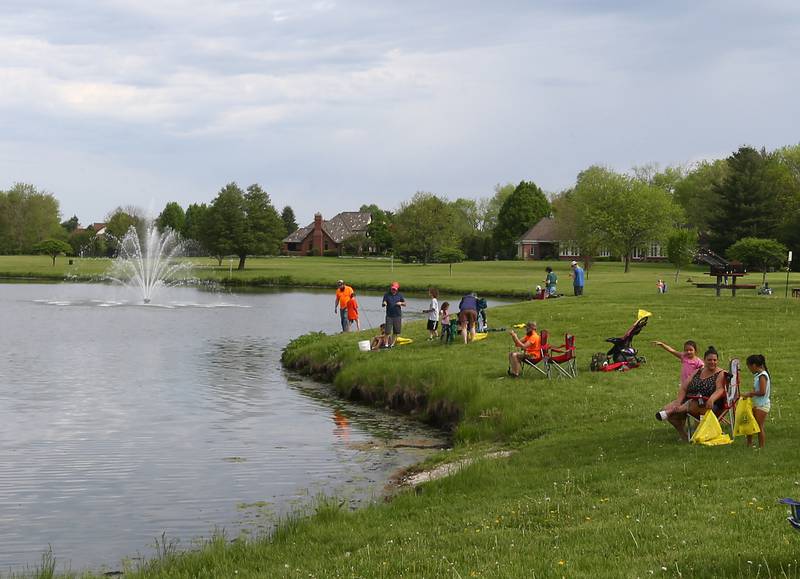 Kids and families gather along the shoreline of Baker Lake for the 22nd Annual Kids Fishing Expo on Saturday, May 14, 2022 at Baker Lake in Peru.