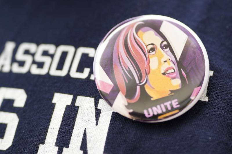 Torrick Ward wears a button with the face of Vice President Kamala Harris at a meeting of volunteers who will be canvassing for Harris and other Democrats in Michigan and Wisconsin, Sunday, July 28, 2024, at the 49th Ward offices in Chicago. (AP Photo/Erin Hooley)
