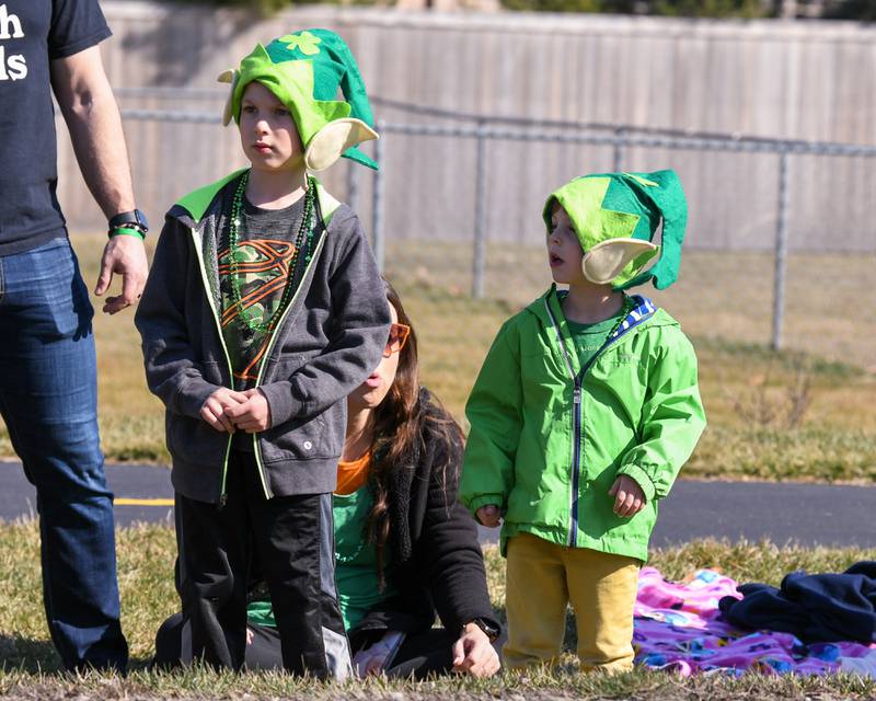 Siblings Jaxon,6, and Luca Gebhart, 3, of Countryside watch the Countryside St. Patrick’s Day parade on Saturday March 1, 2024.