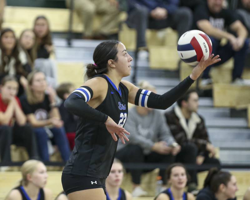 St Charles North's Haley Burgdorf (23) serves during Class 4A Glenbard West Sectional final volleyball match between St Charles North at Benet. Nov 6, 2025 in Glen Ellyn.