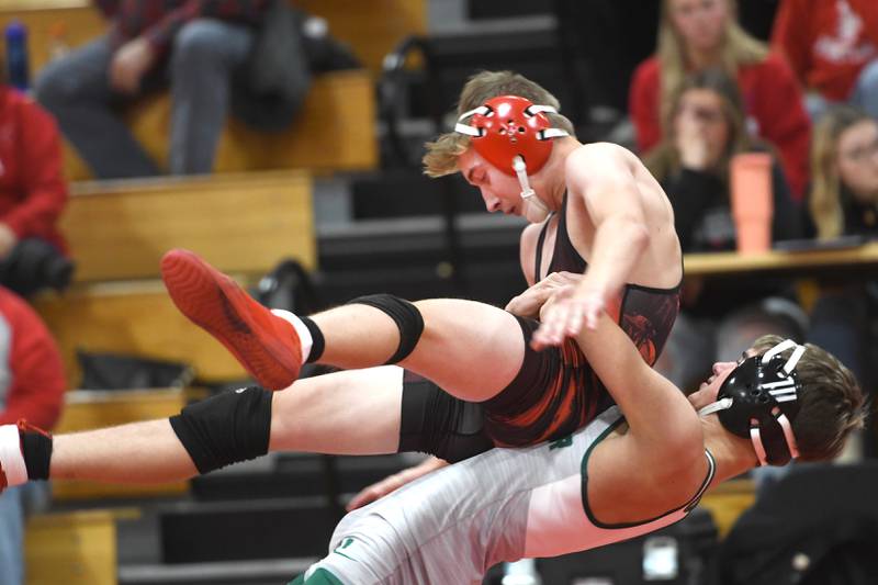 West Carroll's Jack McIntyre lifts Amboy's Ty Florschuetz during their 132 pound match at Oregon High School on Tuesday, Nov. 25, 2025.