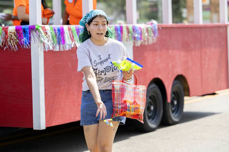Marching with the Sauk Valley Chamber of Commerce, Ale Reyes tosses out candy Saturday, Sept. 14, 2024, during the Fiesta Days parade. The parade started and Rock Falls and ended at the Grandon Civic Center in Sterling.