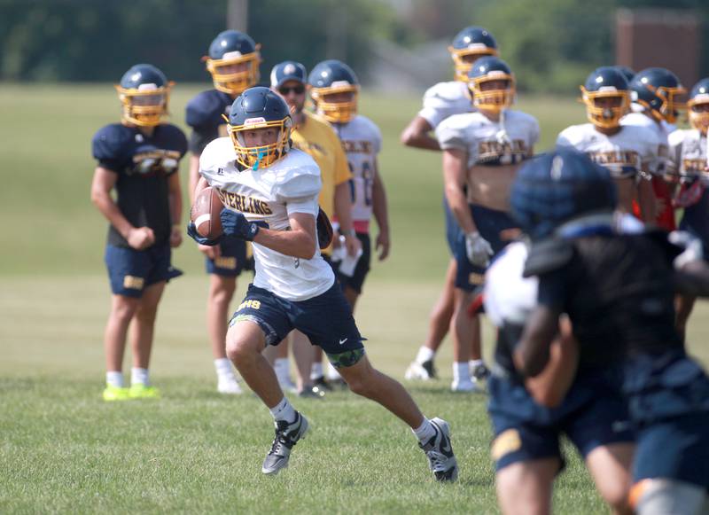 Sterling’s Cobey Shipma runs the ball during a joint practice with Glenbard South and Oswego East football teams on Tuesday, July 15, 2025 in Oswego.