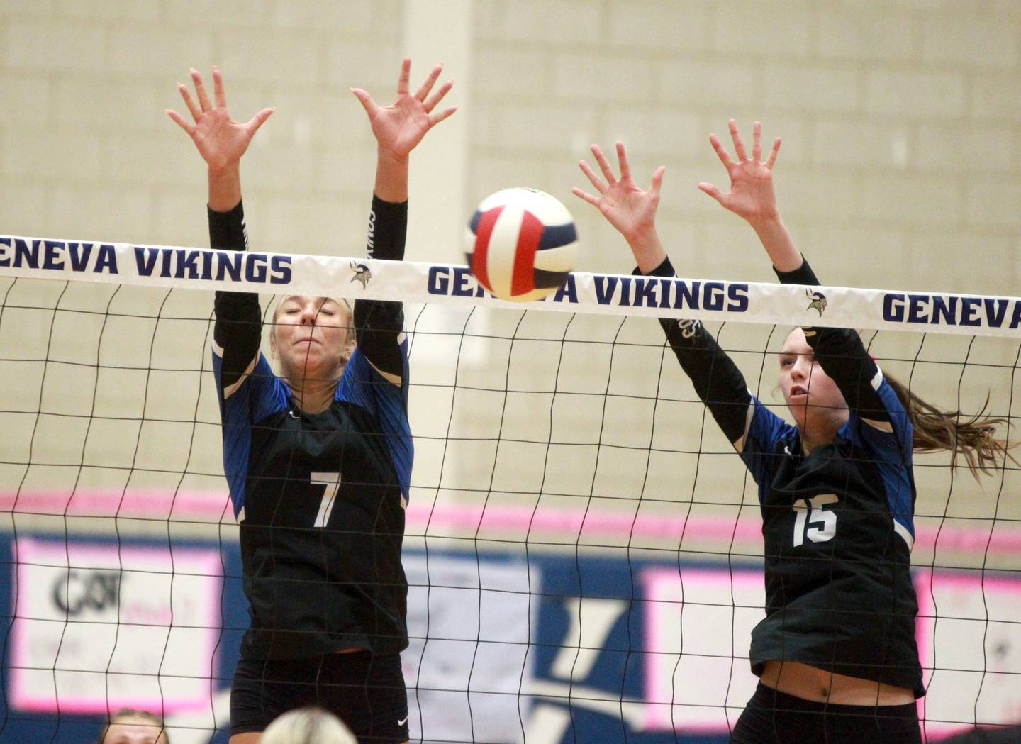 Geneva’s Sam Vanda (left) and Fiona Turnbull (right) go up for a block during a game against St. Charles North on Tuesday, Oct. 22, 2024 at Geneva.