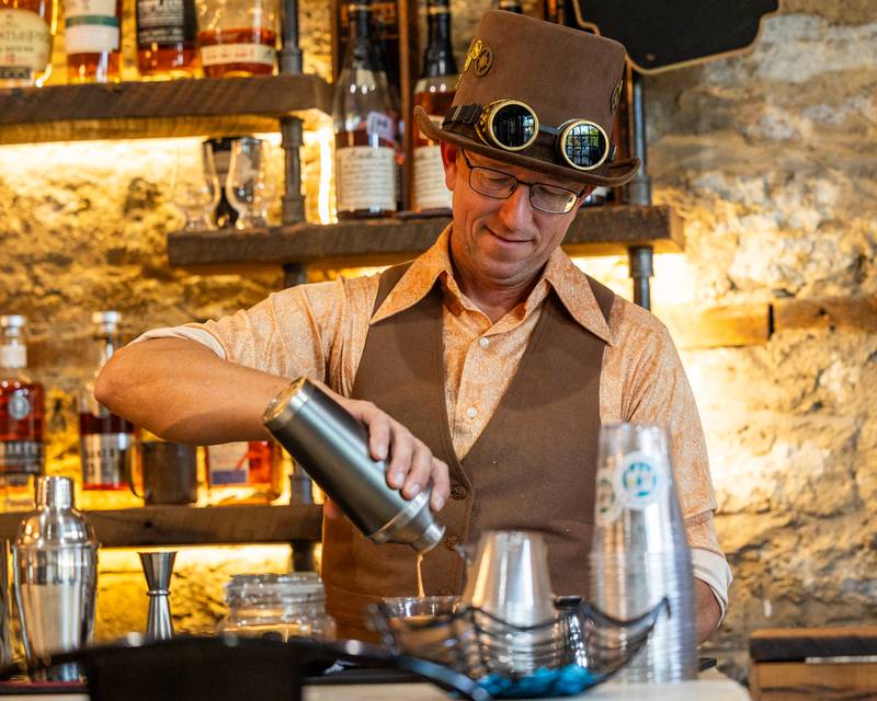Matt Cetwinski of Bruce and Ollie’s pours mixed drinks at the annual Witches Walk on Friday, Oct. 17, 2025, at the Market on Mill in Utica.