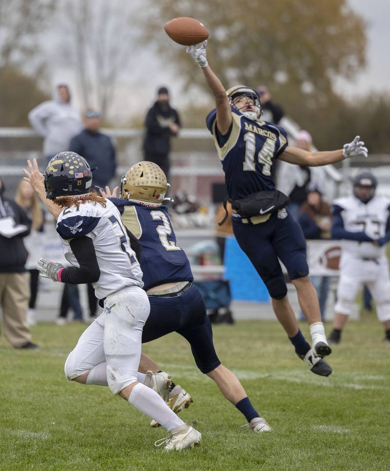 Polo’s Jordan Reed tips a pass against Hiawatha Saturday, Nov. 1, 2025, in the 8-man football playoff quarterfinals.