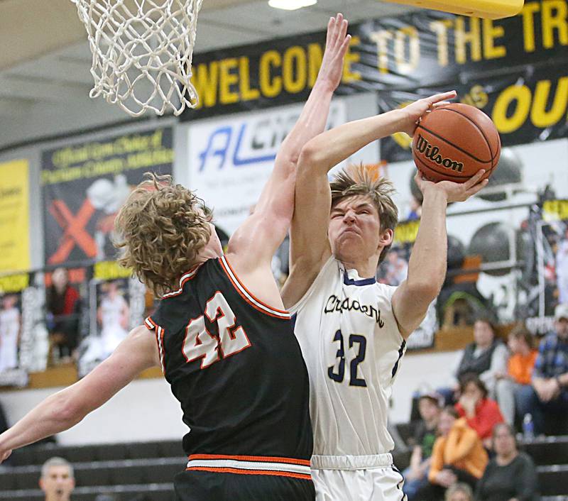 Marquette's Henry McGrath is fouled by Roanoke-Benson's Zeke Kearfott on a drive to the basket during the Tri-County Conference Tournament on Wednesday, Jan. 25, 2023 at Putnam County High School.
