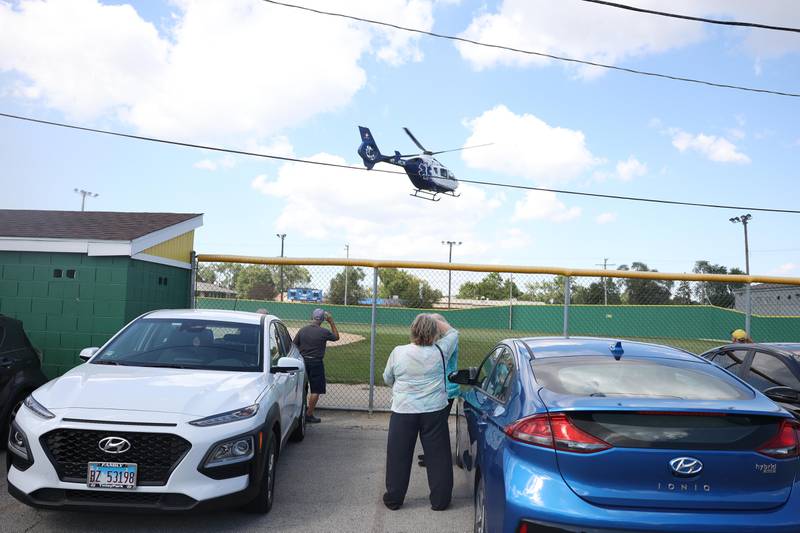 People watch as a medical helicopter leaves after being on display at the Crest Hill Lions Luau and Car Show on Sunday, Sept. 1, 2024 in Crest Hill.