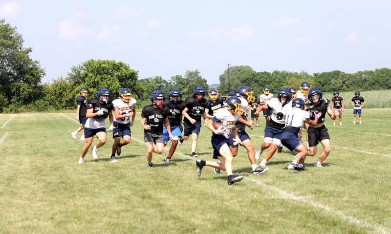 Sterling and Oswego East play against each other during a joint practice with Glenbard South on Tuesday, July 15, 2025 in Oswego.