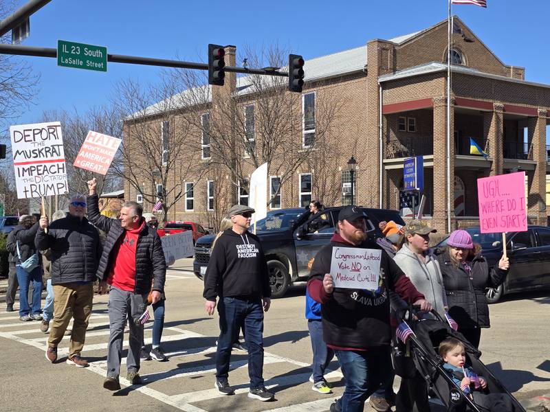 Residents crossed La Salle Street in Ottawa on Saturday, March 8, 2025, on their way to Washington Square in the March for Democracy. The event focused on equality for all citizens and was critical of measures taken by the Trump administration that they said threatens people's rights.